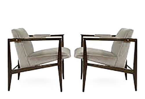 Edward Wormley designed these chairs with modern lines. The chairs are gray and angled backward with squared off arms of dark wood.