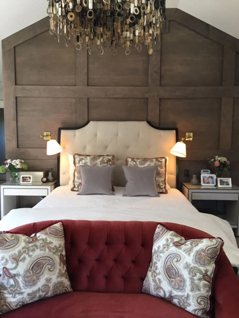 A bedroom with wood panelling as a headboard provides texture and allows the room to shine.
